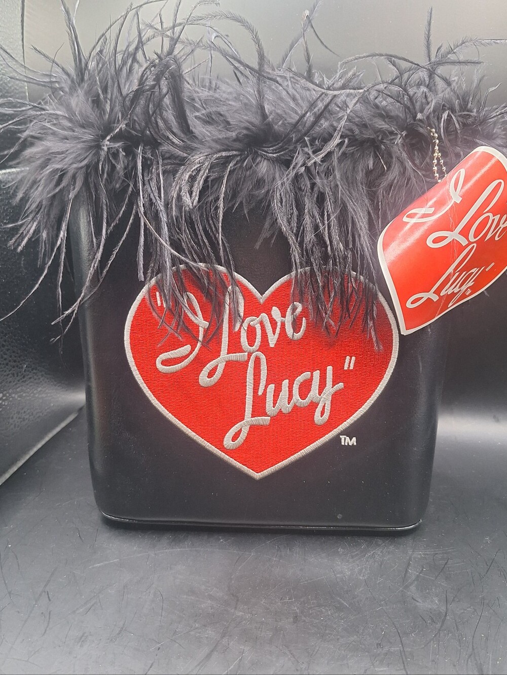 I Love Lucy bucket purse is a stylish shoulder bag with a solid black.